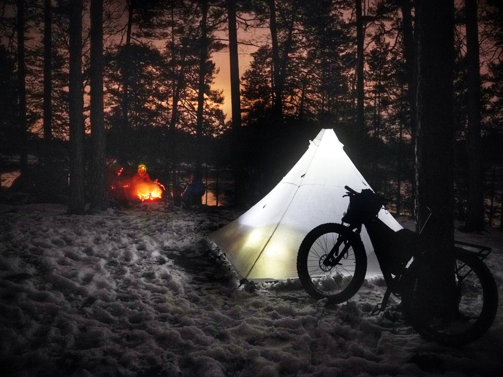 Camp around a fire in the Swedish forests.