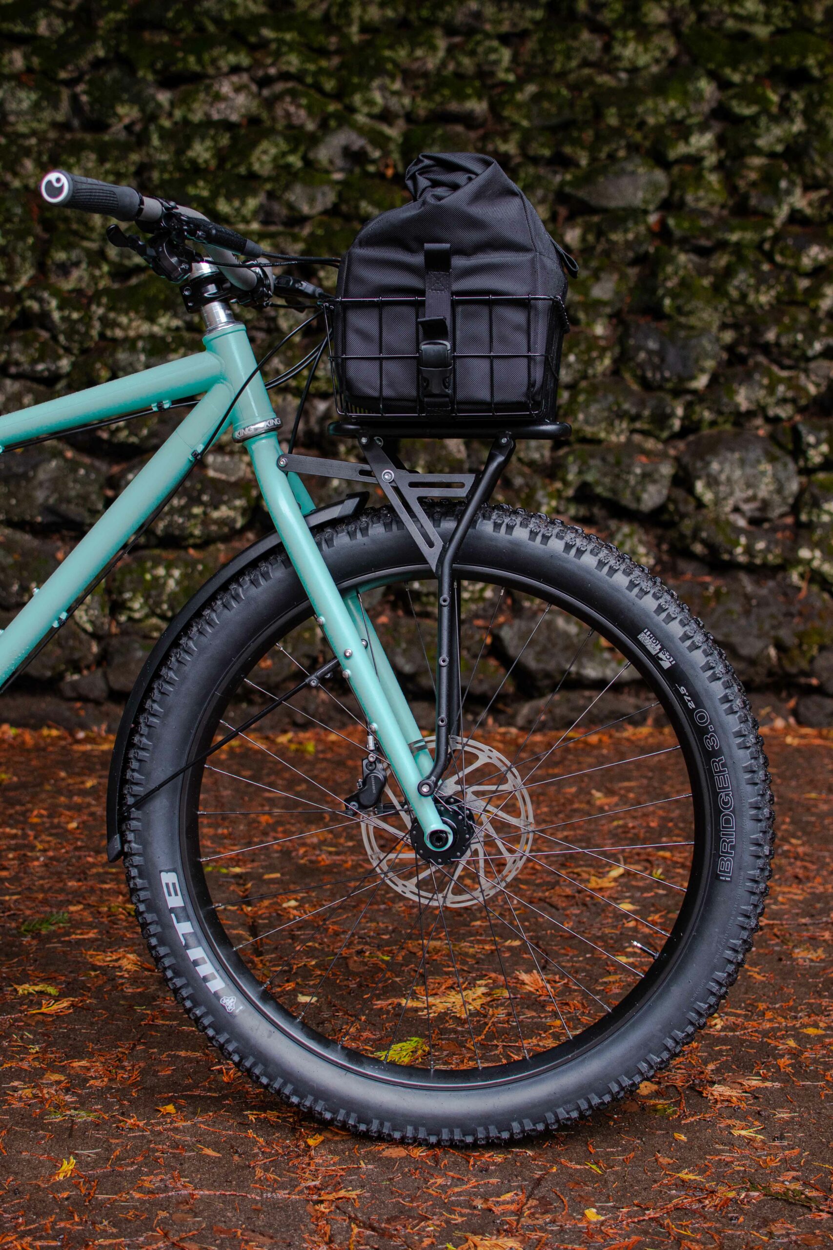 Front fork of bike against a stone wall