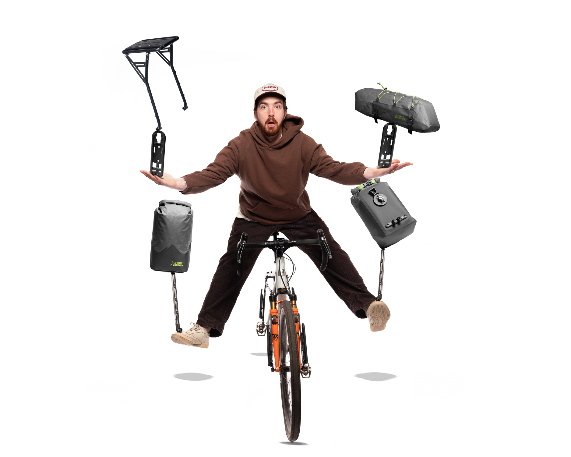 A man floating on a bike balancing bikepacking bags like a circus performer.
