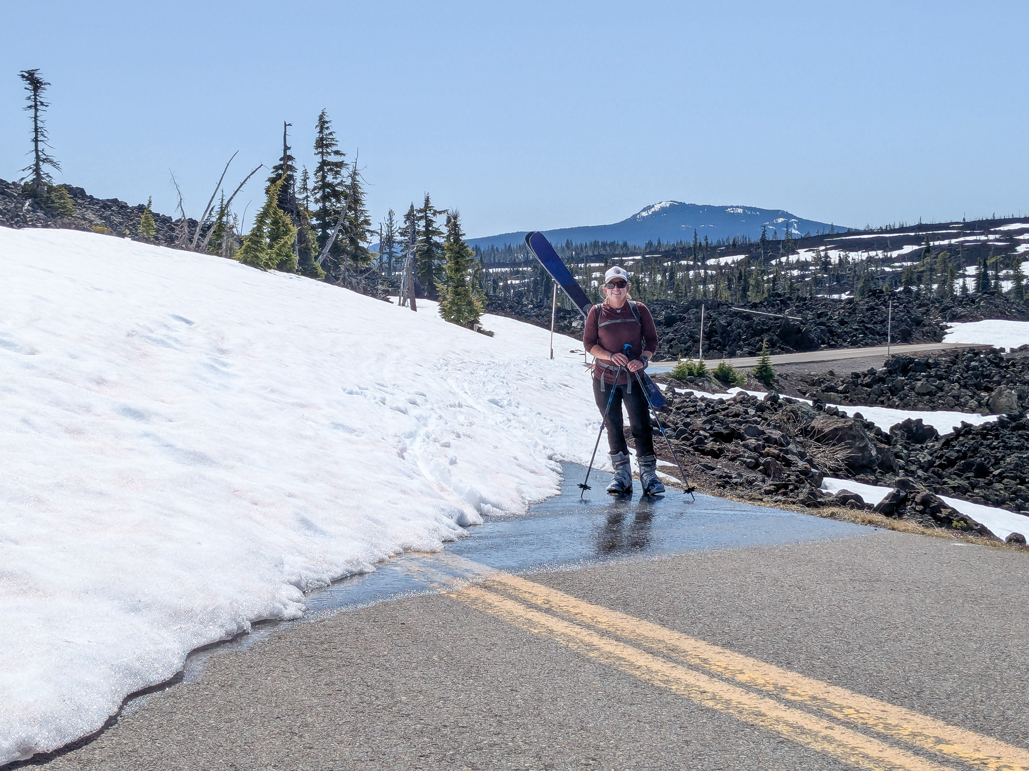 Katy standing in highway that runs into a snow bank.