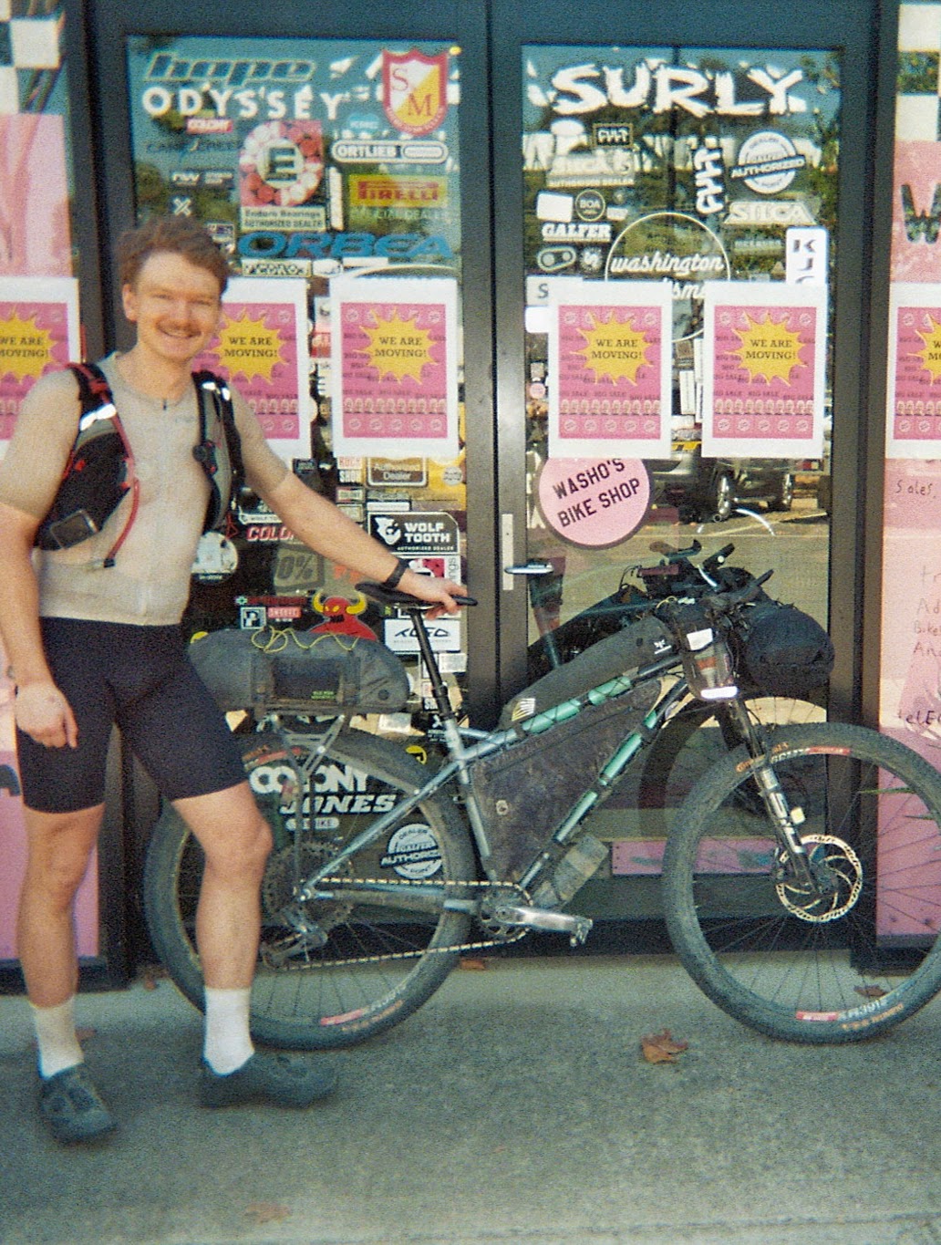 Lorenz and his bike in front of a bike shop.