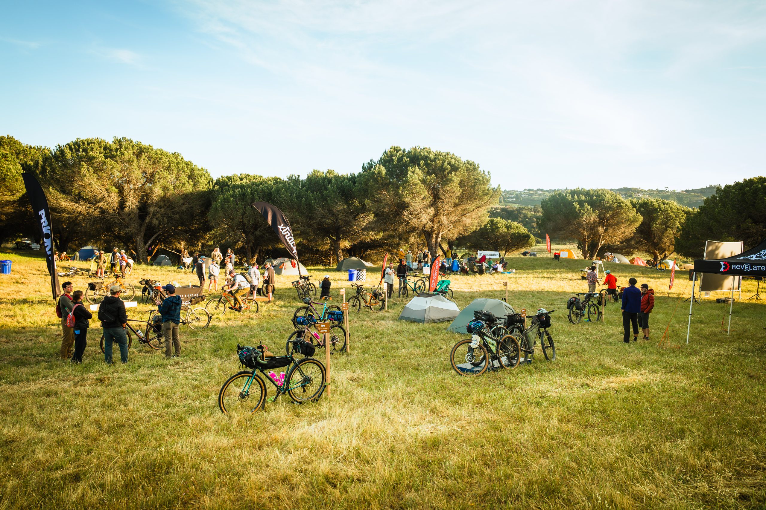 Field full of bikes and cyclists at the Bikepacking Campout.
