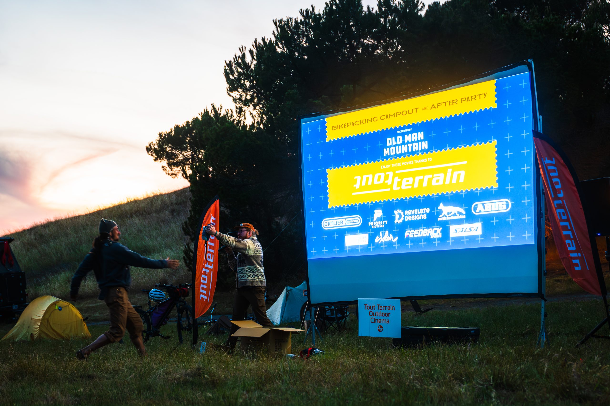 Raffle prize being handed to winner in evening light.