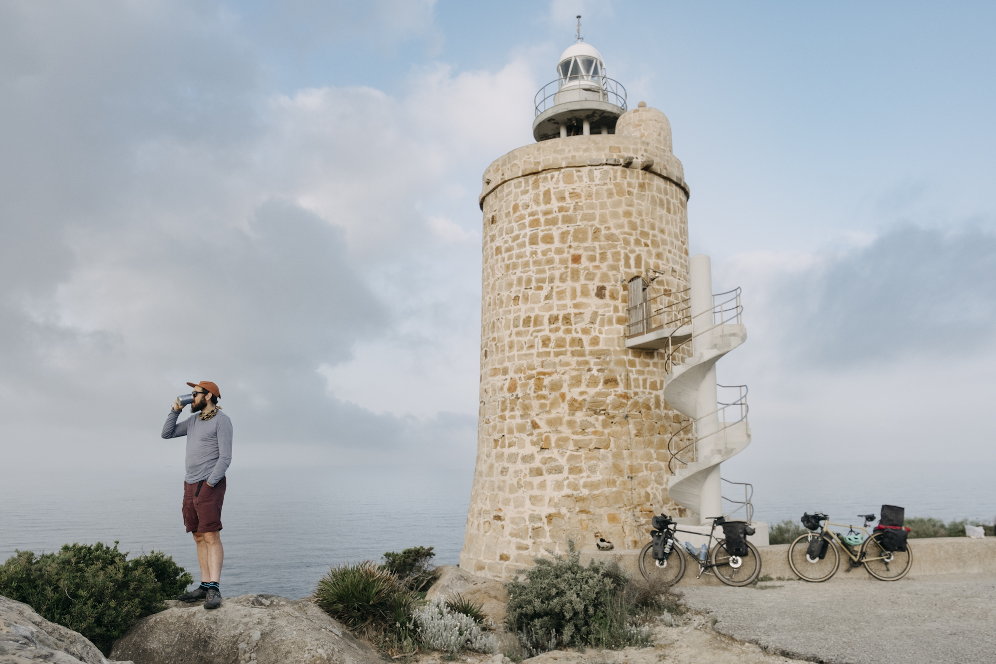 Angustias_Tour_TomasMontes-55 Javi having coffee in front of a lighthouse.